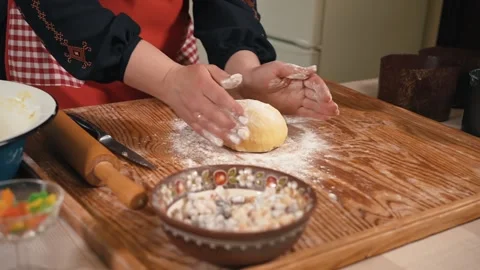 Female hands preparing dough for Easter bread in the kitchen, dough with flour Stock Footage 253916667
