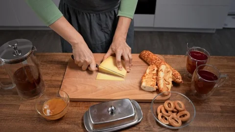 Female hands preparing a snack: tea and bruschetta with butter and cheese. Close Stock Footage 316287995