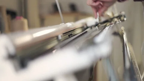 Female hands preparing weaving machine for work in workshop Stock Footage 87453245