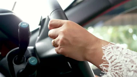 Female hands pressing the button the adaptive Cruise Control while driving a car 動画素材 143761548