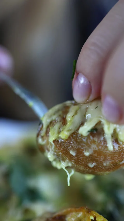 Female hands pull a snail out of a conch shell with a fork. macro. Stock Footage 249110376