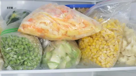 Female Hands pulls frozen Bell pepper out of the fridge. Frozen  vegetables Stock Footage 146030134