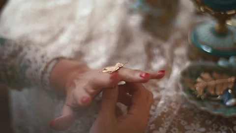 Female hands put on a beautiful ring. The concept of women's gatherings Stock Footage 186984232