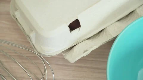 Female hands put a box of eggs on the table and take one egg from a box 库存影片 132067616