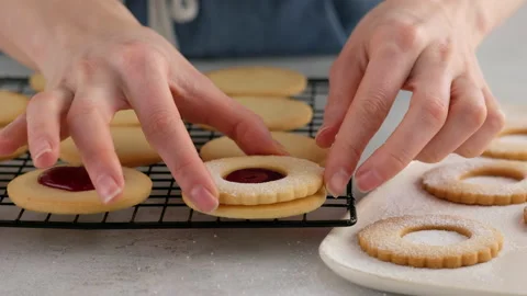 Female hands put cookies on the second cookie with jam. Female hands a making Stock Footage 146502827