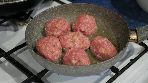 Female hands put the cutlets from minced meat pan fried in oil Stock Footage 77566873