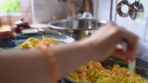Female hands put fried eggs into glass blue plate from frying pan. Healthy Stock Footage 306309306