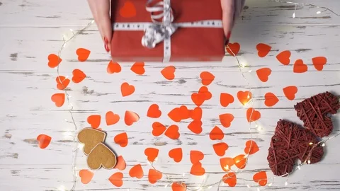 Female hands put a gift box on the desk, top view down. Video stock 122248225