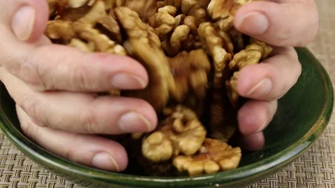 Female hands put peeled walnuts Stock Footage 124249241