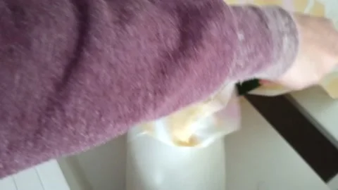 Female hands put the pillow case on the rough for filling with feather after Stock Footage 164972007