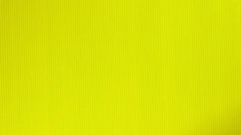 Female hands put a slice of watermelon on a bright yellow background. Minimal Video stock 100289846