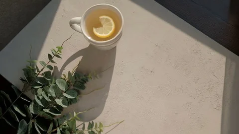Female hands put on the table brownie next to the tea Stock Footage 79524951