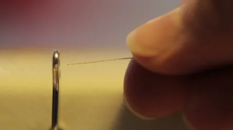 Female hands put a thread through a needle, close up Stock Footage 60746970