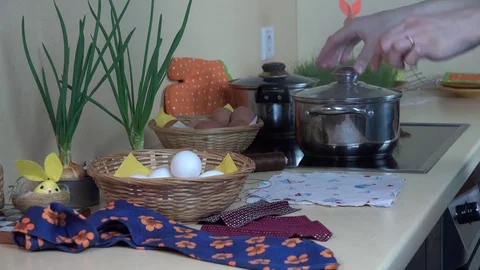 Female hands put white egg into silk material. Easter eggs painting Stock Footage 74114117