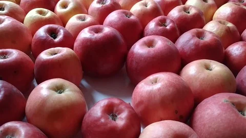Female hands puts down one apple into a bunch Stock Footage 116426928