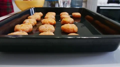 Female hands puts fish cotlets on a baking sheet . Concept homemade food. Stock Footage 146403565