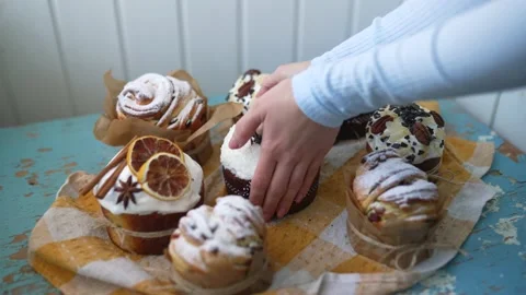 Female hands putting Easter cakes creatively decorated with white icing, candied Stock Footage 236141682