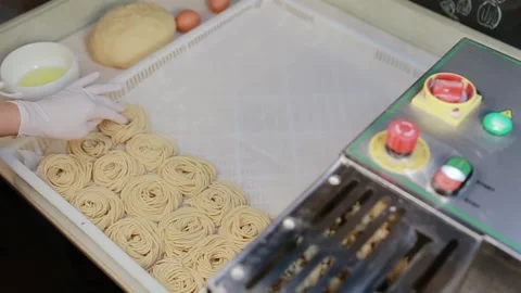 The female hands putting uncooked spaghetti or tagliatelle into plastic tray Stock Footage 134681493