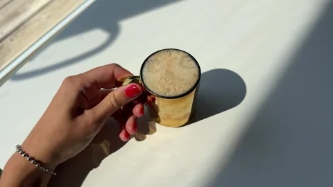 Female hands with red manicure picking up a hot cup Stock Footage 342071354