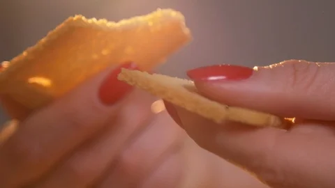 Female hands with red nails cracking crisp bread in slow motion closeup Stock Footage 120876724
