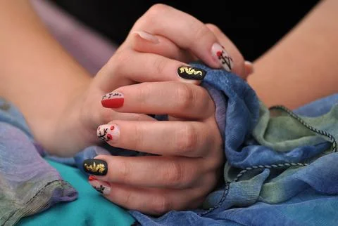 Female hands resting casually on a table Stock Photos