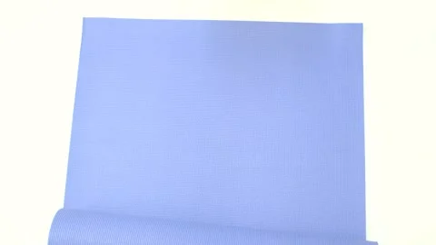 Female hands roll up rubber blue exercise mat on a white background close-up Stock Footage 214617529