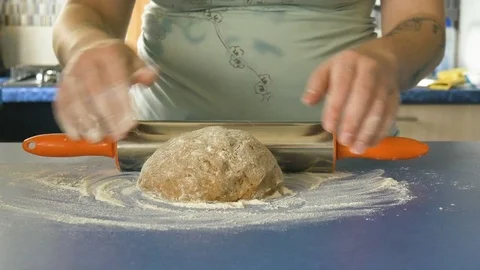 Female hands rolling dough with rolling pin, 4K color graded Stock Footage 83615317