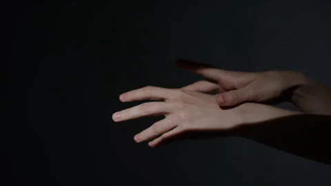 Female Hands Rotating, Touching Wrists and Intertwining in Light Stock Footage 284922564