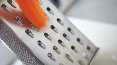 Female hands rub carrots on the table. Stock Footage 205923428