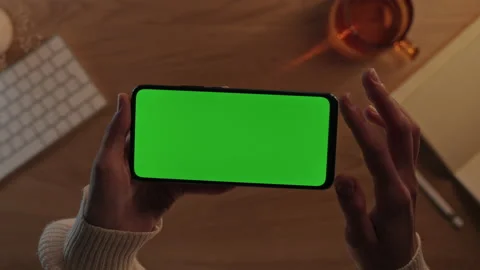 Female hands scrolling and tapping on mobile green screen Stock Footage 162731916