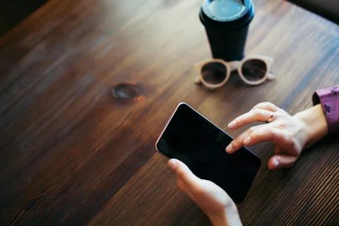 Female hands scrolling the screen of mobile phone. 스톡 사진