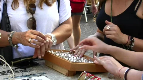 Female hands selecting and trying jewelry and ring Stock Footage