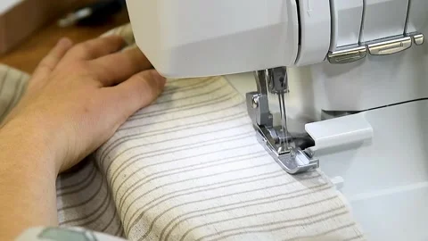 Female hands on sewing machine. Close up of seamstress work. Vídeos de archivo 328829720
