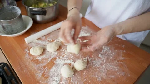 Female hands shape the dough into a cake. Cooking pies. Stock Footage 154228593