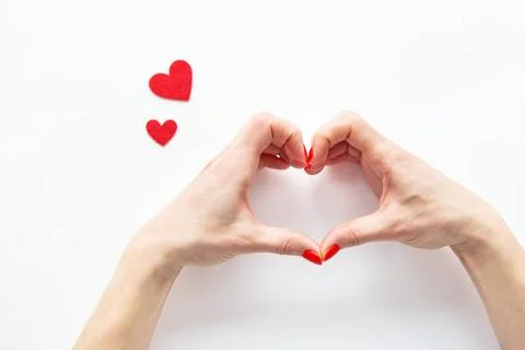 Female hands in the shape of a heart isolated on a white background, side ... Stock Photos