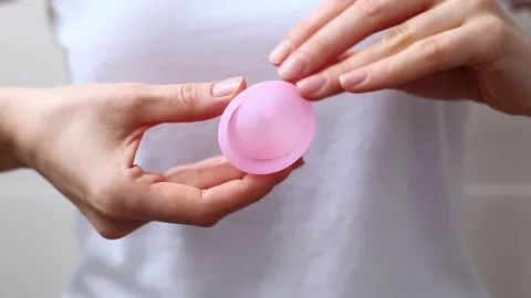 Female hands show using menstrual cup. Woman hand holding menstrual cup. Female Stock Footage 167290258