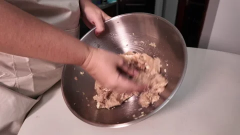 Female hands skillfully mix minced meat and finely chopped onion in a metal bowl Stock Footage 319372325