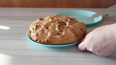 Female hands slicing an applepie at table Stock Footage 143574696