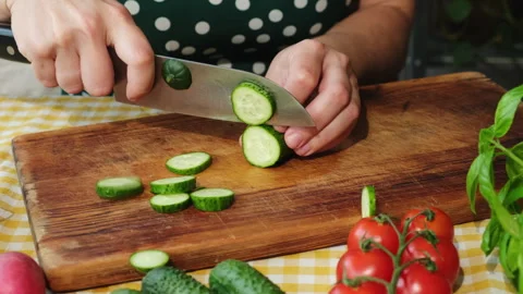 Female hands slicing fresh cucumber to make vegetable salad Stock Footage 336366202