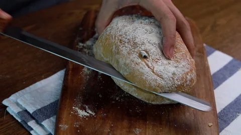 Female Hands Slicing Olive Bread On Wooden Table Stock Footage 160156737