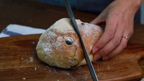 Female Hands Slicing Olive Bread On Wooden Table Stock Footage 160157183