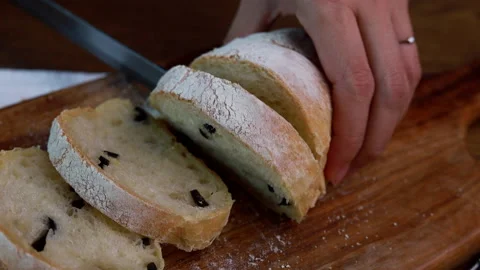 Female Hands Slicing Olive Bread On Wooden Table Stock Footage 160157436
