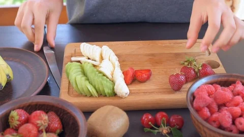 Female hands slicing strawberry. Stock Footage