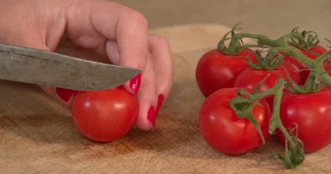 Female hands slicing tomatoes with kitchen knife, 4K Stock Footage 89509406