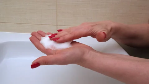 Female hands with soap bubbles over white bathroom sink Stock Footage 271067167