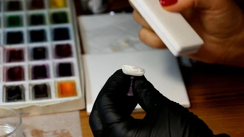 The female hands of a specialist in nail design process the workpiece, close-up Stock Footage