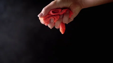 Female Hands Squeeze Wet Orange Rag Against Hot Steam Background Stock Footage 312013780