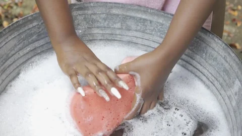 FEMALE HANDS SQUEEZING SOAPY SPONGE Video stock 145451443