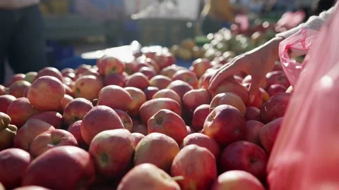 Female hands stack apples in an bag in street market close-up. Stock Footage 169836281