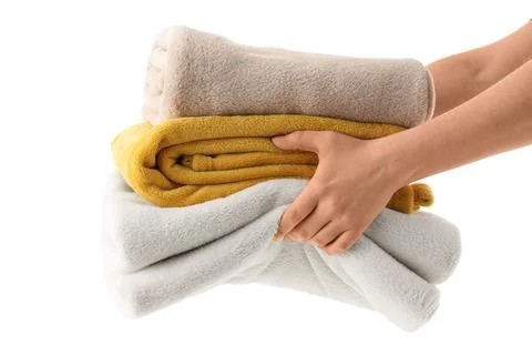 Female hands with stack of blankets isolated on white background Stock Photos